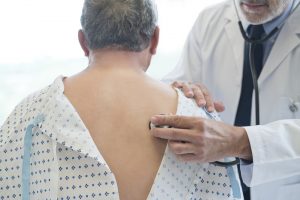 Doctor examining patients lungs, back, chest exam