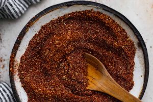 Overhead shot of mixed chipotle seasoning in a bowl with wooden spoon sticking out of it.