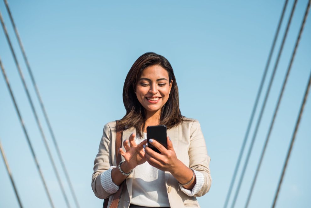 A woman uses her smartphone outside.