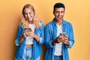 Excited couple using phone apps to save money