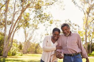 Older couple walking outdoors in a park