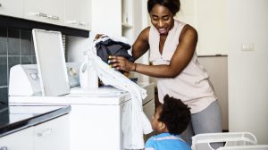 Mother doing laundry with her child