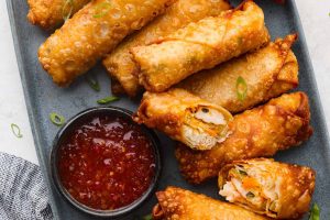 Overhead shot of a plate full of fried shrimp egg rolls.