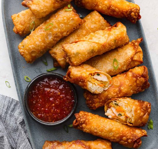 Overhead shot of a plate full of fried shrimp egg rolls.