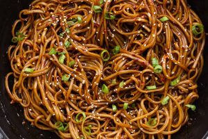 Overhead shot of cooked teriyaki noodles in a skillet.