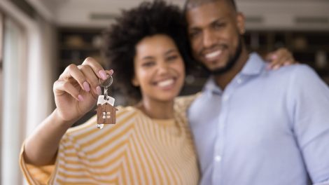 Happy couple with house keys