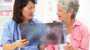 Doctor and patient look at an x-ray