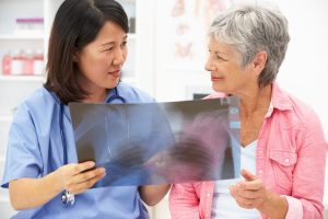 Doctor and patient look at an x-ray