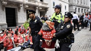 NEW YORK, UNITED STATES - OCTOBER 14: Officers from New York Police Department detain some protesters and intervene in the Pro-Palestinian demonstration outside New York Stock Exchange building in New York, United States on October 14, 2024. (Photo by Fatih Aktas/Anadolu via Getty Images)