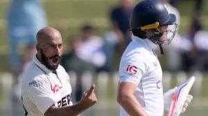 Pakistan's Sajid Khan, left, celebrates after taking the wicket of England's Ollie Pope, right, during the day one of third test cricket match between Pakistan and England, in Rawalpindi, Pakistan, Thursday, Oct. 24, 2024. (AP Photo/Anjum Naveed)