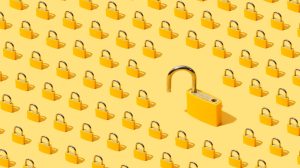 High angle view of many yellow padlocks on yellow background. One of them is open.