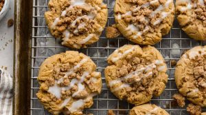 Overhead shot of coffee cake cookies on a cooling rack over a baking sheet.