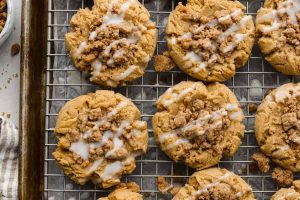 Overhead shot of coffee cake cookies on a cooling rack over a baking sheet.