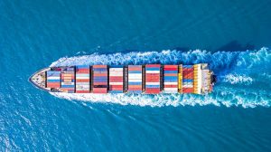 Cargo ship sails on a blue sea.