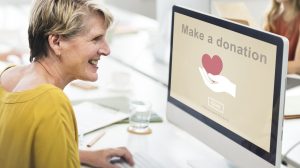 senior woman making donation on computer