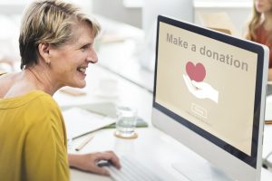 senior woman making donation on computer