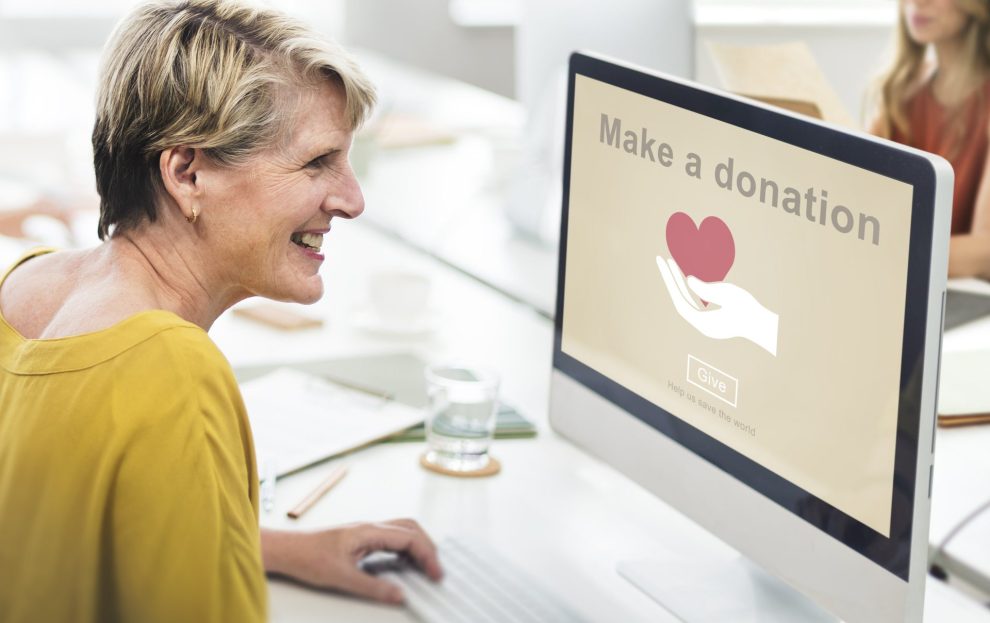 senior woman making donation on computer