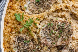 Overhead shot of no peek pork chops and rice in a baking dish.