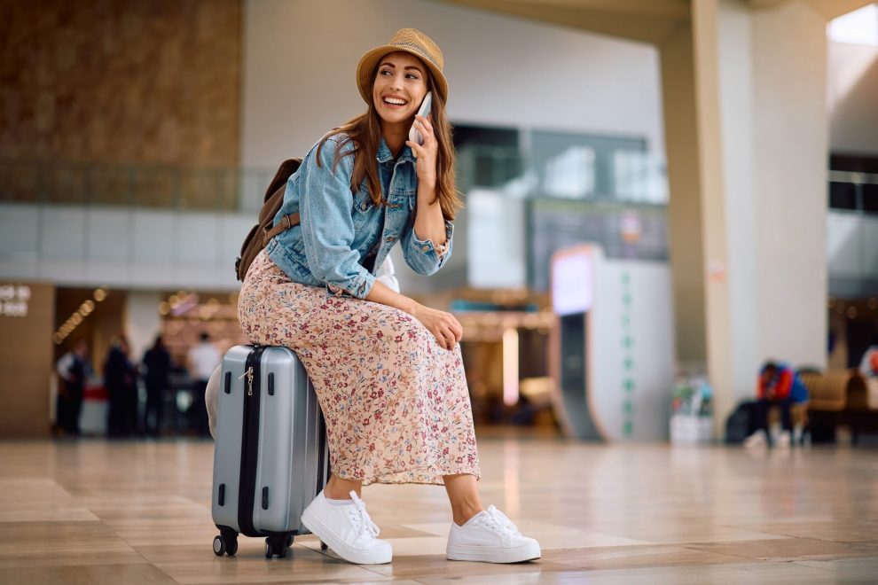 Happy female traveler in the airport